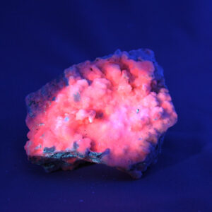 Fluorescent manganocalcite crystal cluster under UV light